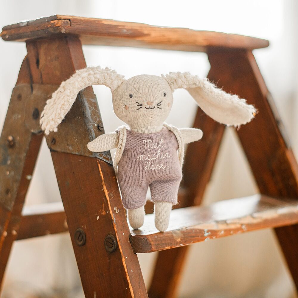 7220_Mutmacherhase_Anzugflieder-scaled Mutmacher Hase mit fliederfarbenem Anzug (16 cm, mit Rucksack) – Bild 1