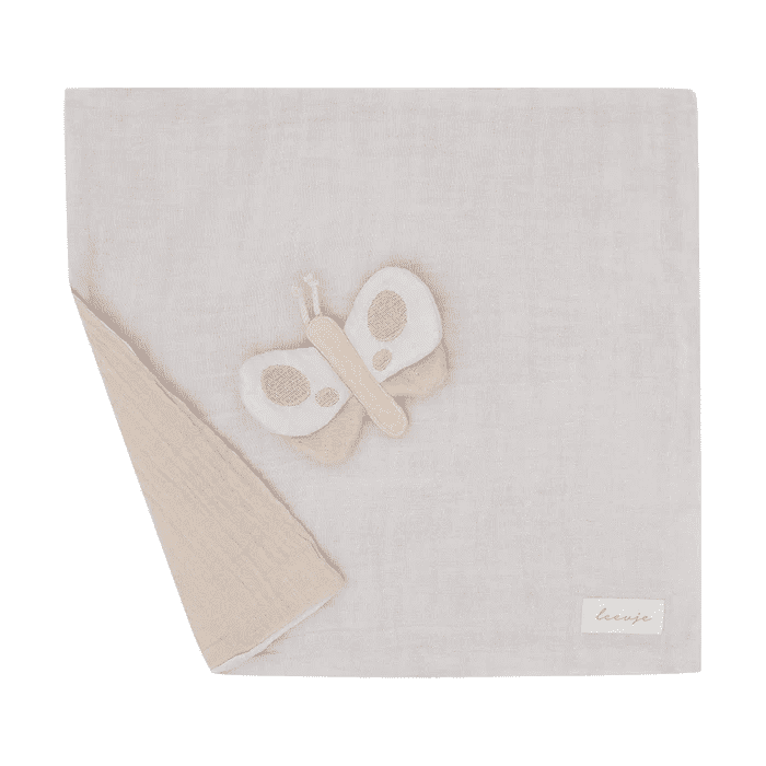 square_image10 Soft light-gray baby blanket with a beige butterfly appliqué and folded corner, brand tag visible bottom-right.